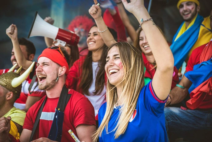 Football fans having fun and looking at football match