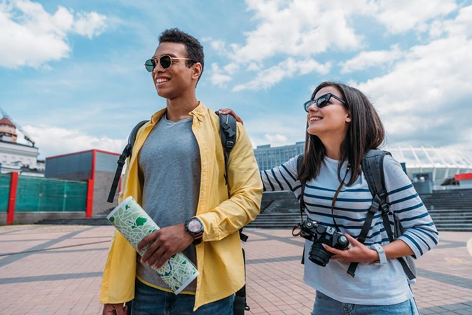 woman in sunglasses holding digital camera